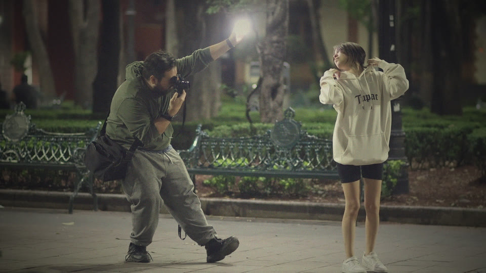 Photographer directing a model in a city park